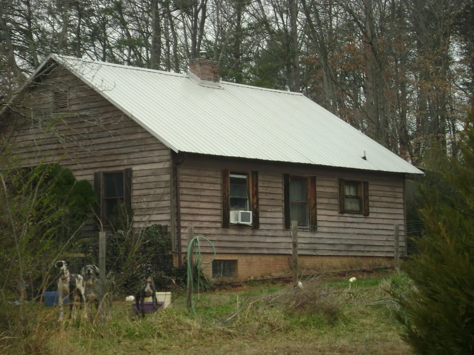 White metal roof on an old wood sided farmhouse, from a Metal Roof Installation job in Hazleton